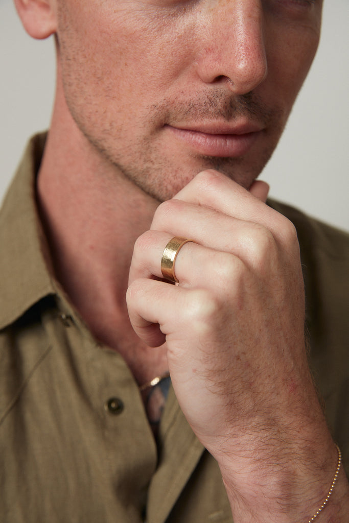 close up of man's hand wearing thick gold band