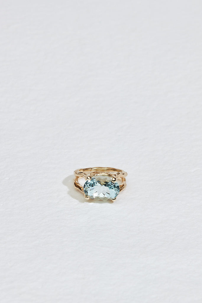 gold split textured band with oval aquamarine