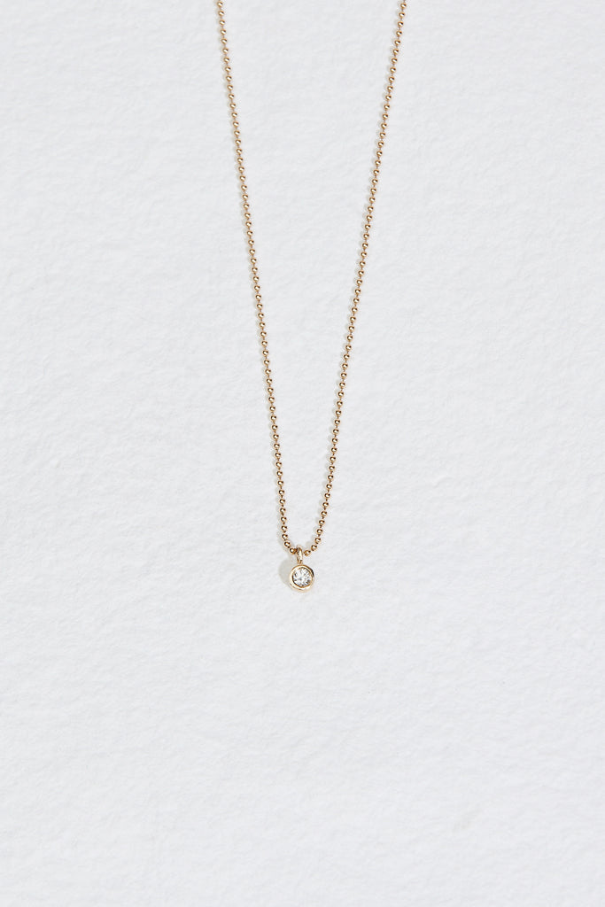 bezel set round diamond ring on ball chain necklace