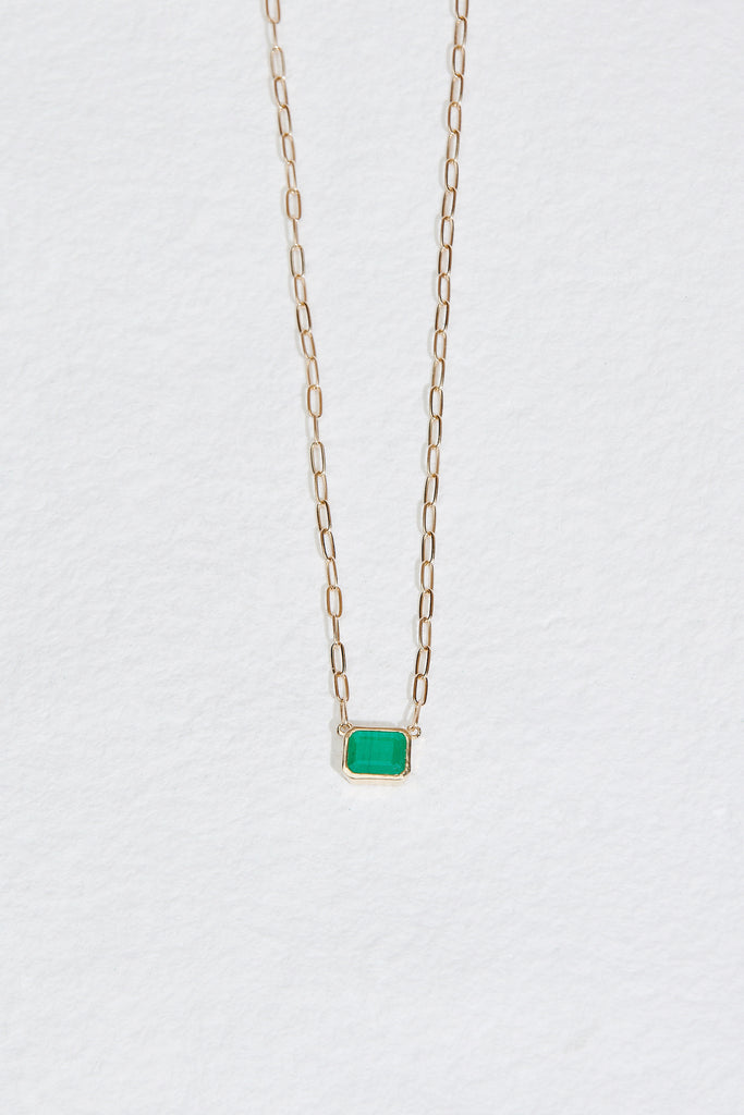 gold cable chain necklace with bezel set emerald cut emerald