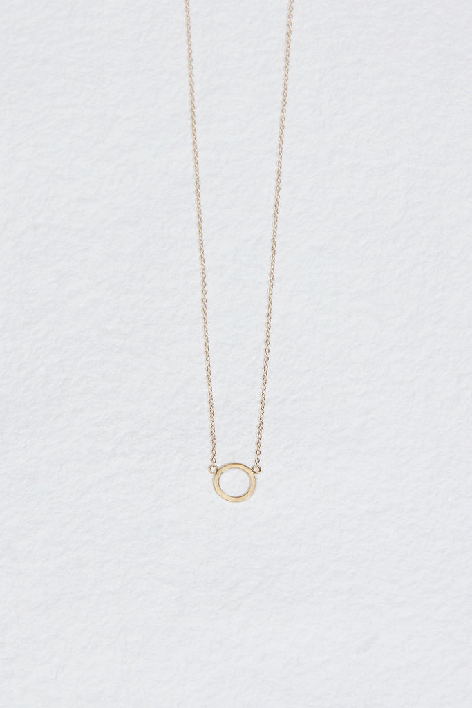 gold necklace with gold circle