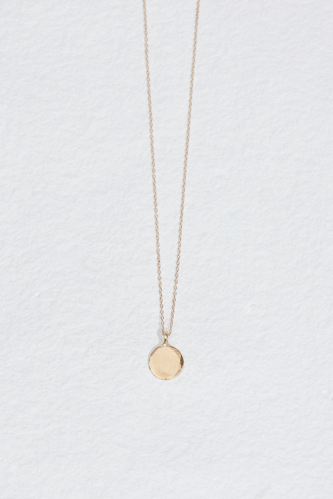 gold necklace with round disk