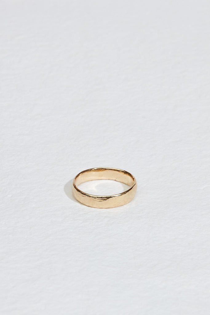 close up of men's gold band with moderate texture