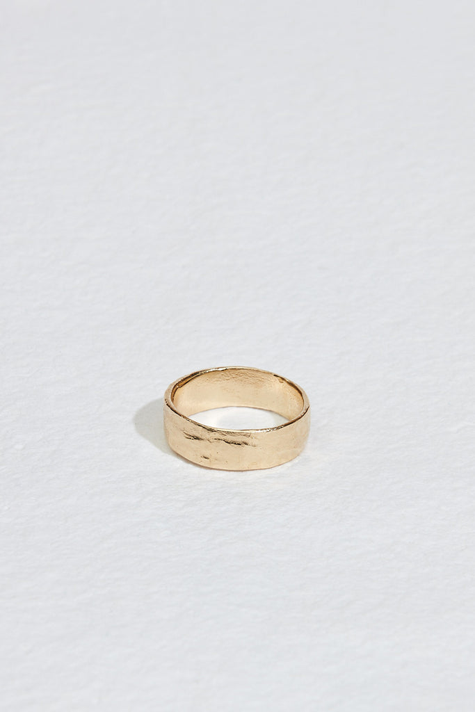 close up of wide men's gold band with straight sides