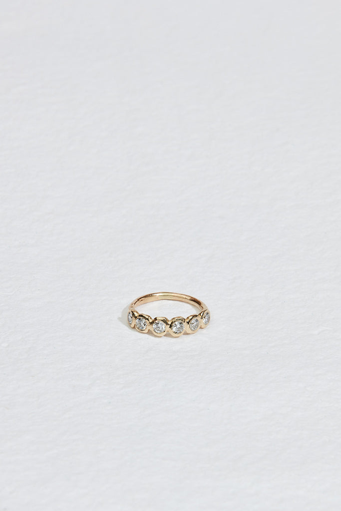 gold band with six bezel set round diamonds