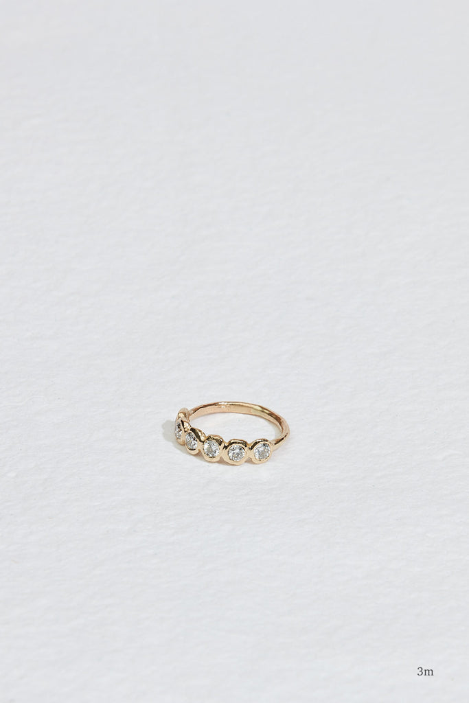 gold band with six bezel set round diamonds