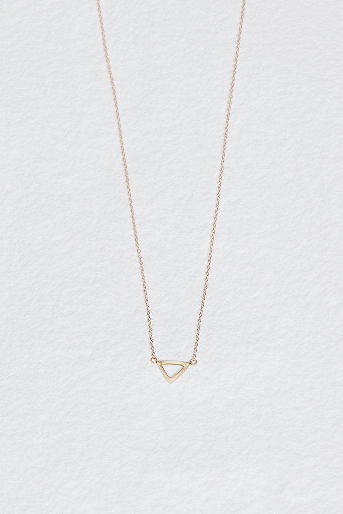 gold necklace with gold triangle