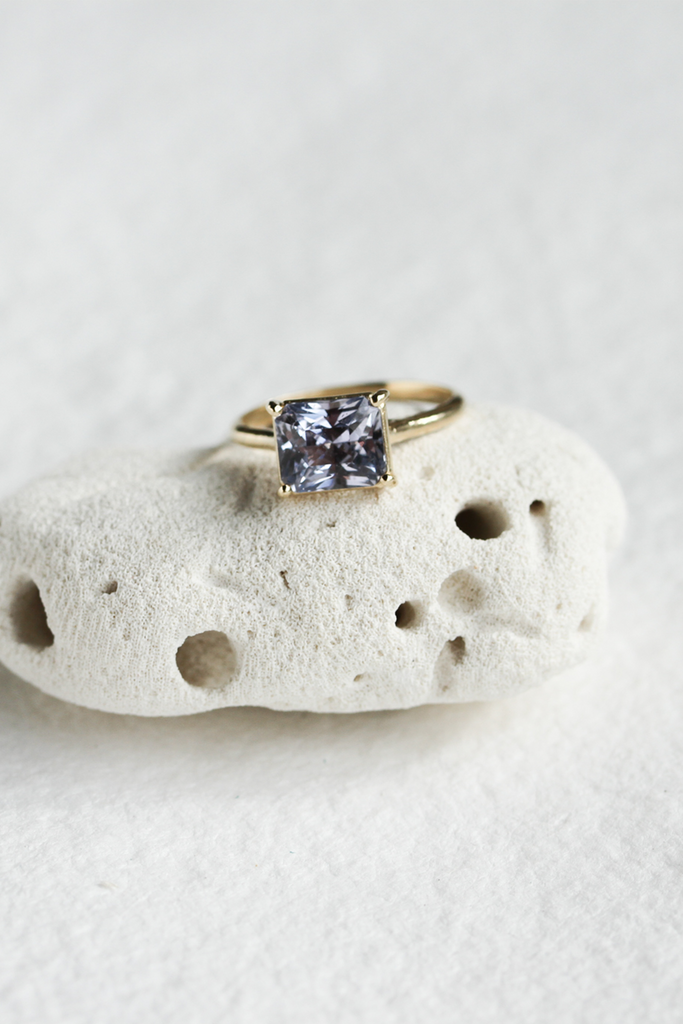 emerald cut violet sapphire cathedral set gold ring