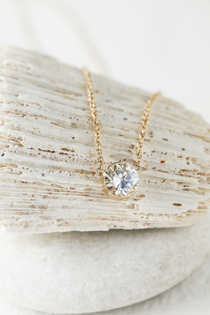 gold partial bezel set round white diamond necklace
