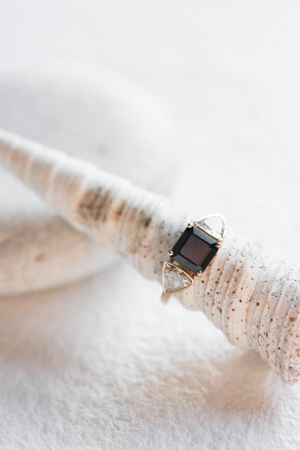 gold ring with asscher cut sapphire with bezel set trillion diamond side stones