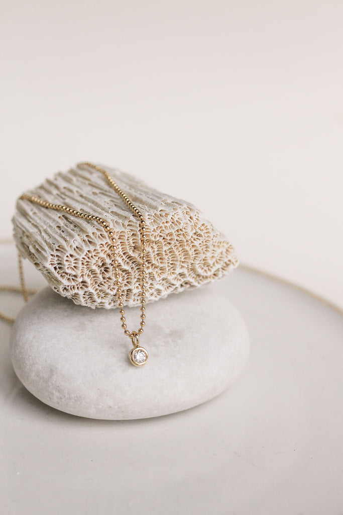 bezel set round diamond ring on ball chain necklace