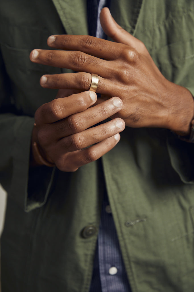 close up of man's hand wearing thick gold band
