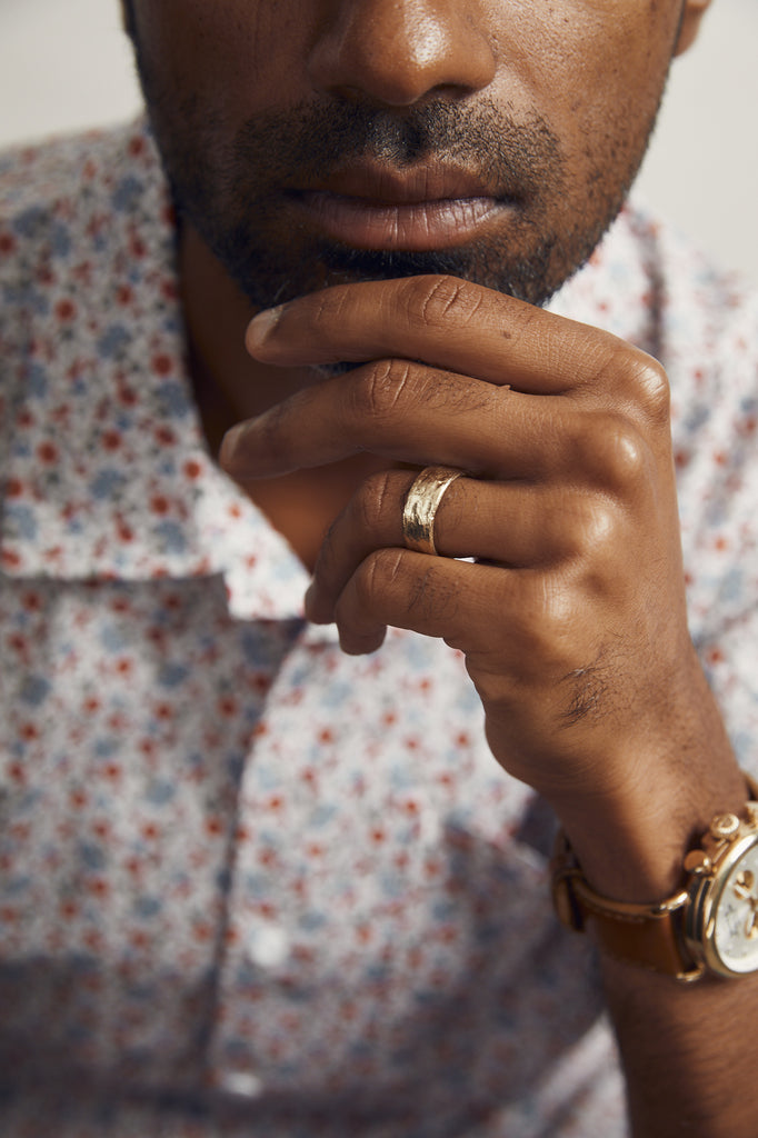 close up of man's hand with wide gold band
