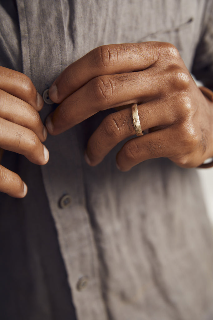close up of man's hand wearing gold band