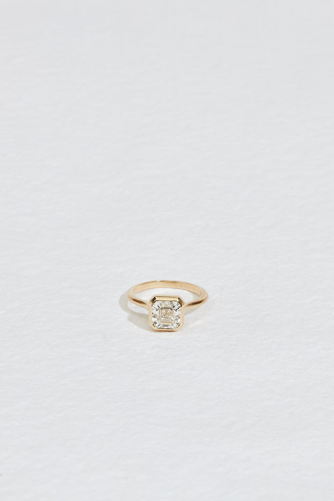 gold ring with bezel set asscher cut white diamond