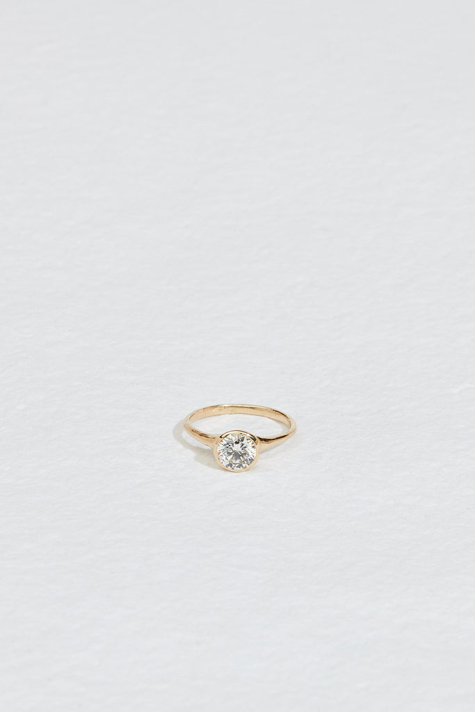 gold ring with bezel set round white diamond