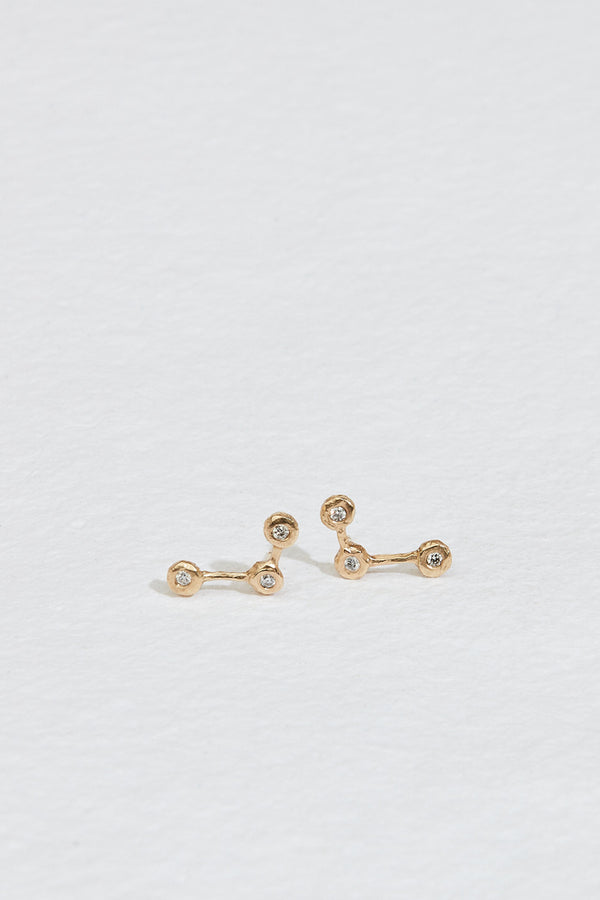 gold constellation inspired stud earrings with three round white diamonds