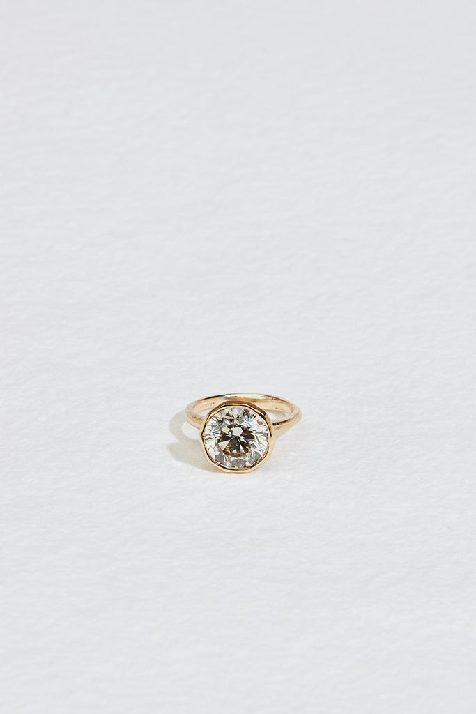 gold ring with decagon bezel set round brilliant diamond