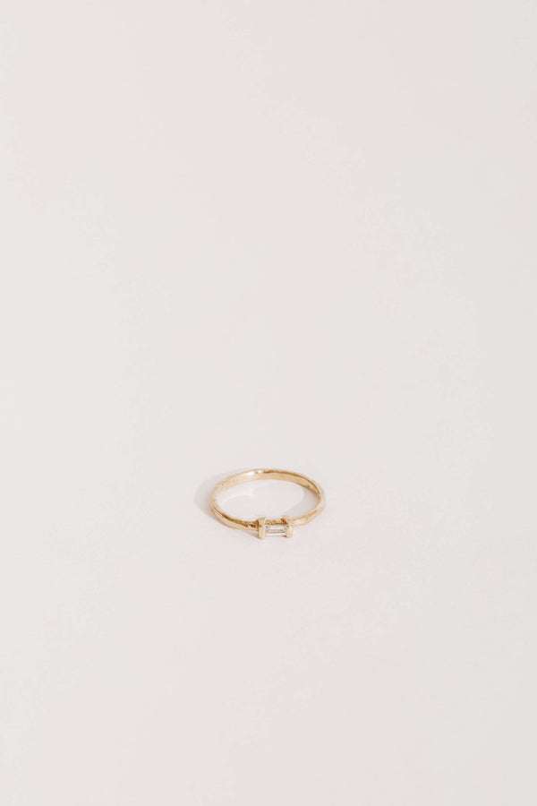 gold band with white baguette diamond