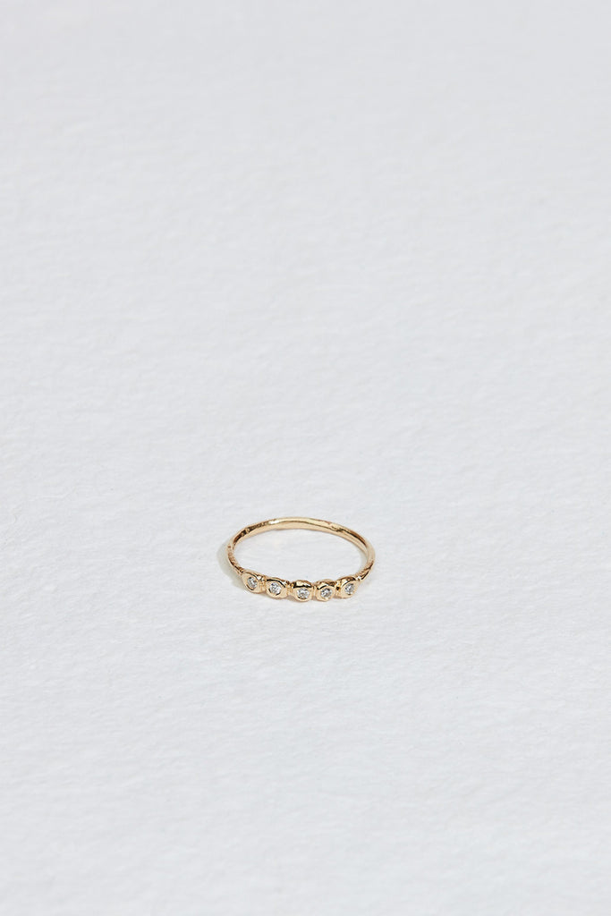 gold ring with five bezel set round white diamonds