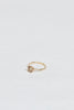 side view of gold four prong ring with cushion cut light champagne diamond
