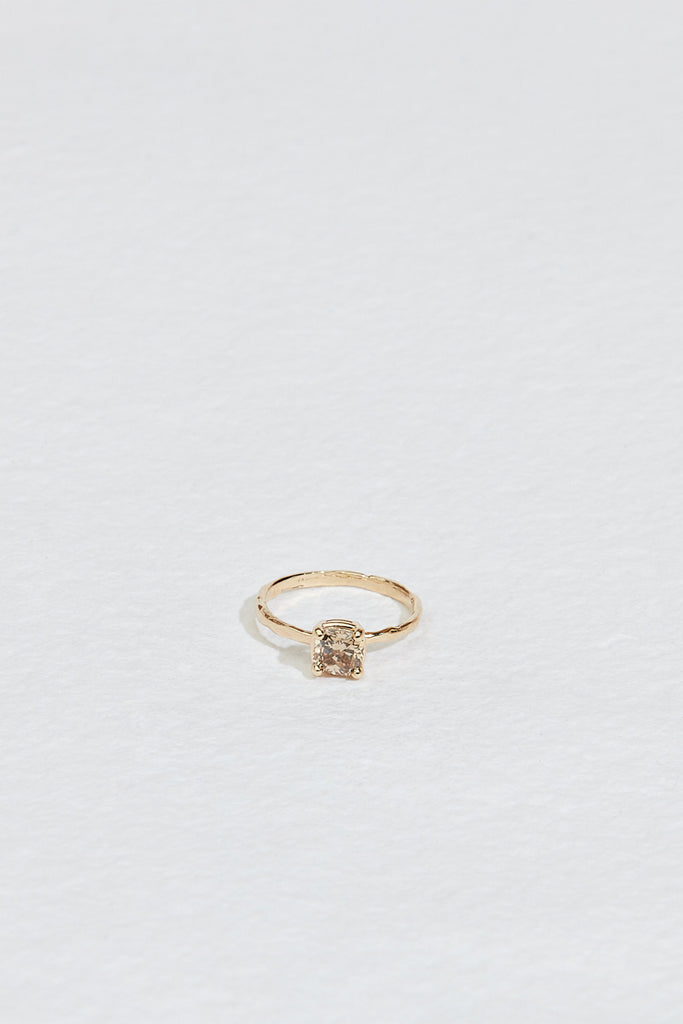 gold four prong ring with cushion cut light champagne diamond