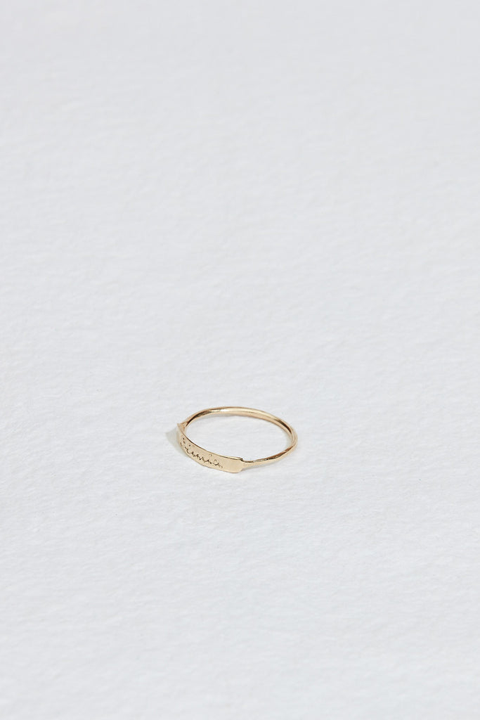 side view of gold ring with hand engraved front plate
