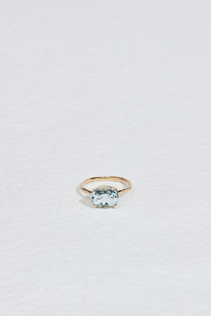 gold four prong oval aquamarine ring with textured band