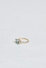 side view of gold four prong oval aquamarine ring with textured band