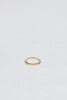 thin gold band with straight sides and round white diamonds