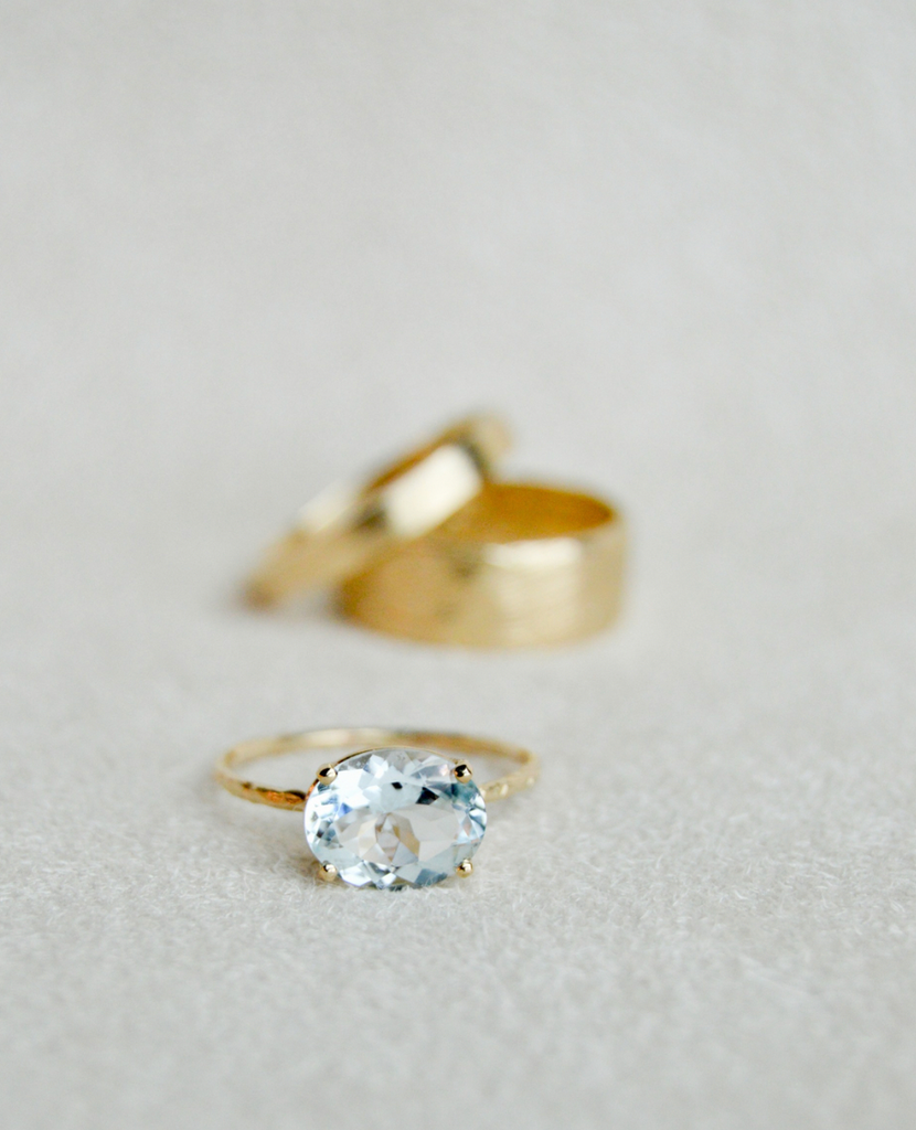 gold four prong oval aquamarine ring with textured band