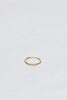 thin gold band with three bezel set round white diamonds