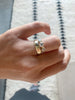 close up of hand wearing 5mm wide gold band with straight sides alongside diamond ring