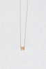 gold necklace with gold square design containing baguette white diamond