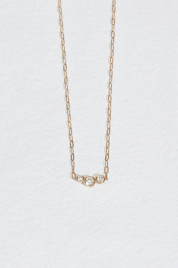 gold cable chain necklace with three bezel set round diamonds
