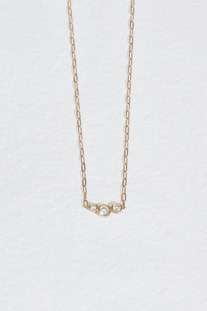 gold cable chain necklace with three bezel set round diamonds