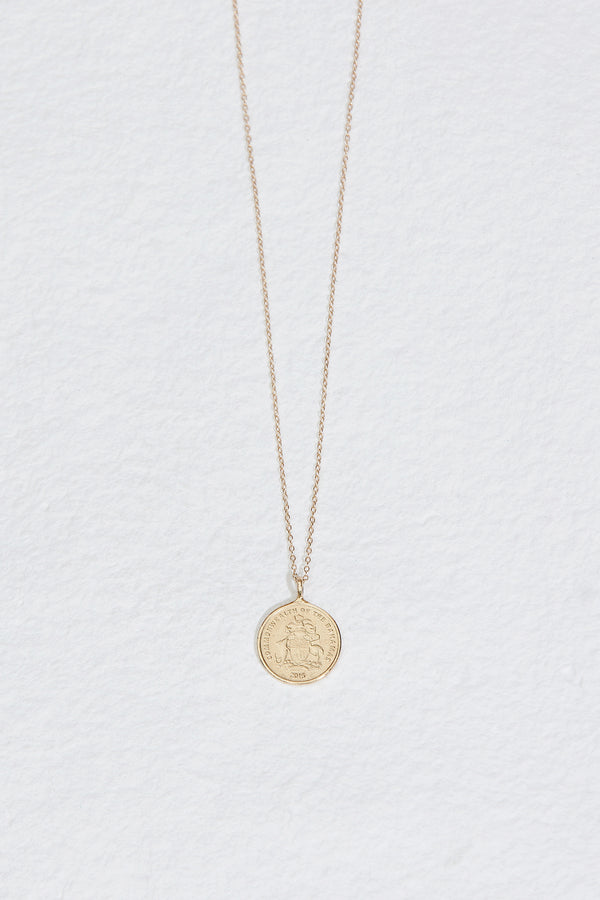 gold necklace with gold cast of bahamian penny