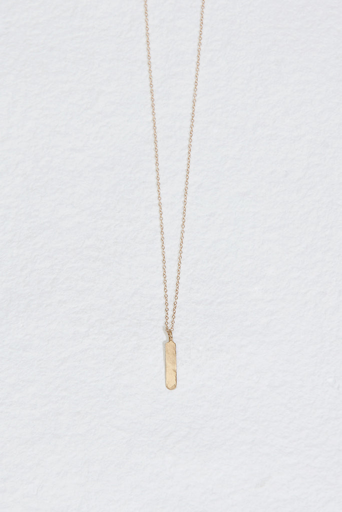 gold necklace with vertical gold bar