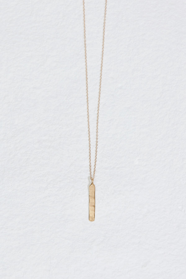 gold necklace with vertical gold bar