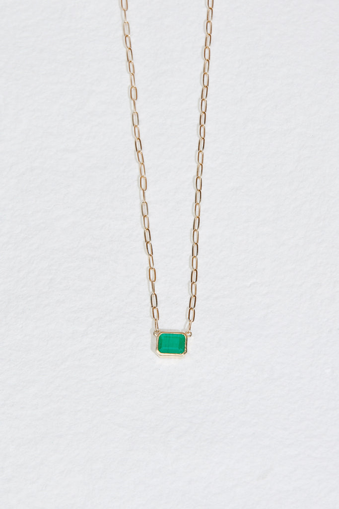 gold cable chain necklace with bezel set emerald cut emerald