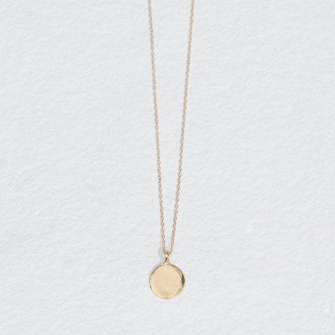 gold necklace with round disk