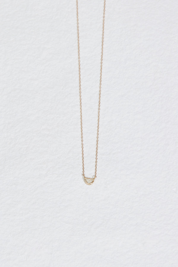 gold necklace with bezel set half moon salt and pepper diamond
