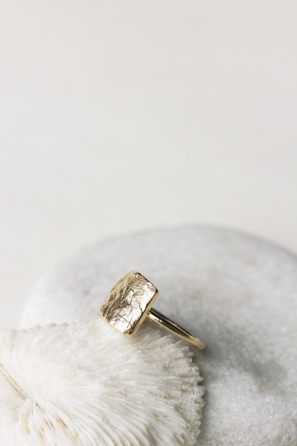 side view of gold ring with engraved dog print