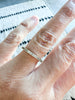 close up of hand wearing gold half-diamond Pavé band