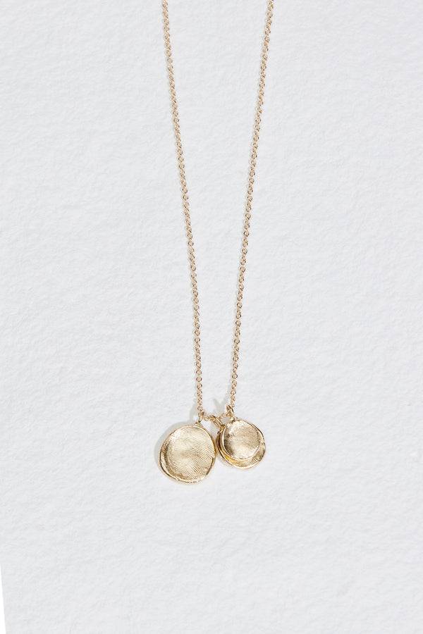 gold necklace with three engraved fingerprint discs
