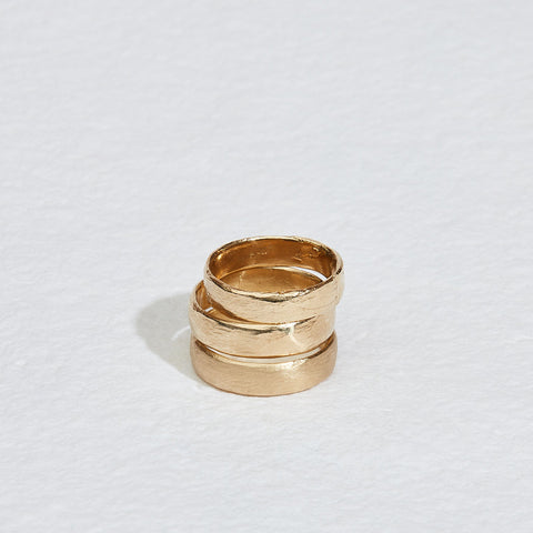 close up of three gold ring bands stacked