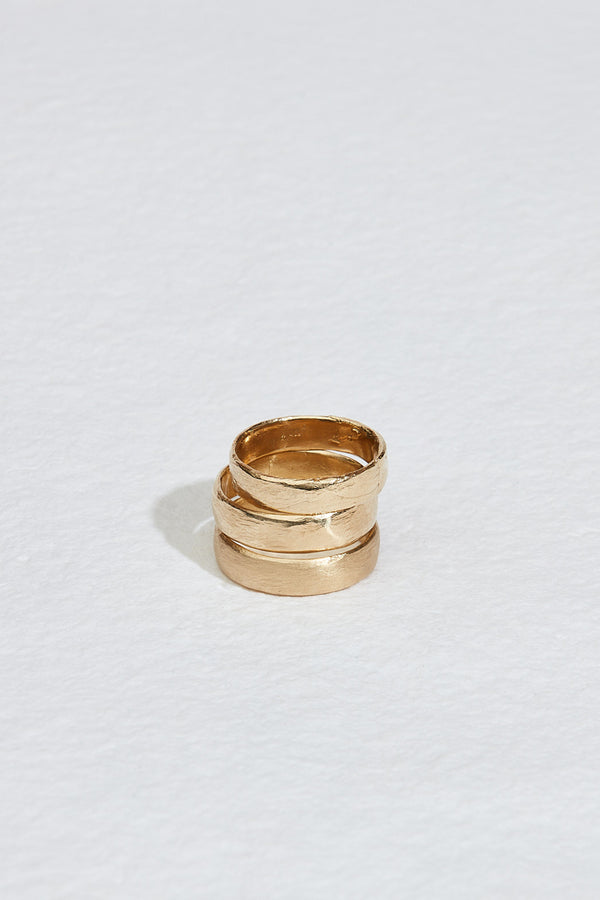 close up of three gold ring bands stacked