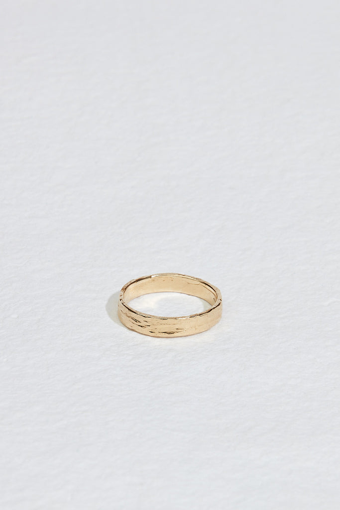 close up of moderately textured men's gold band
