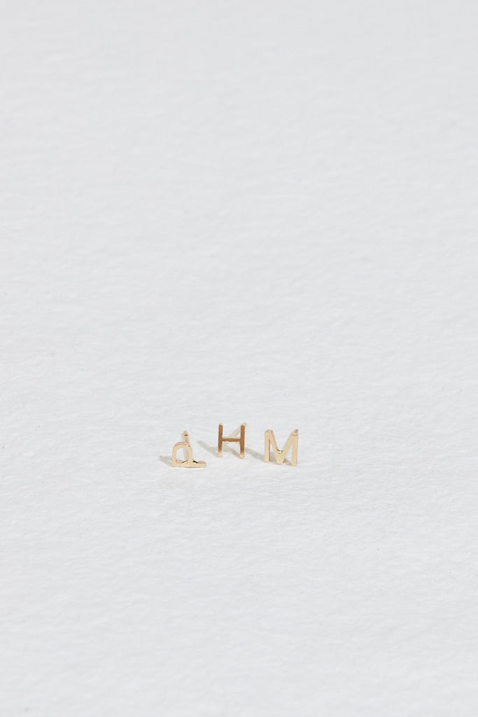 gold letter studs "p", "h", and "m"