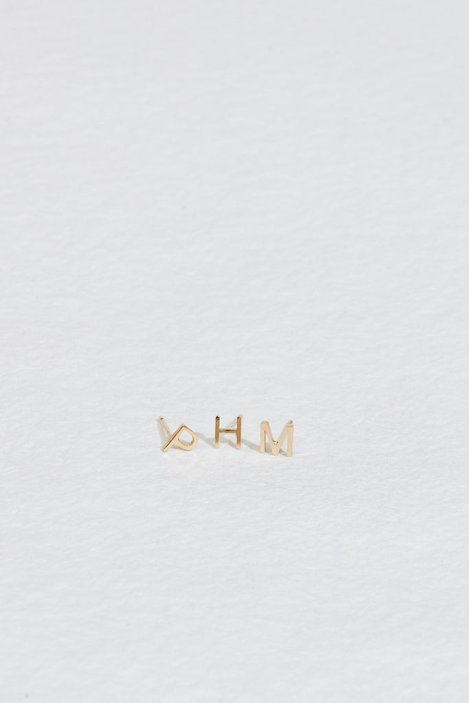gold letter studs "p", "h", and "m"